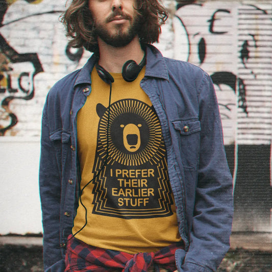 man-wearing-mustard-muso-bear-tshirt-in-urban-setting-with-headphones-festival-fit