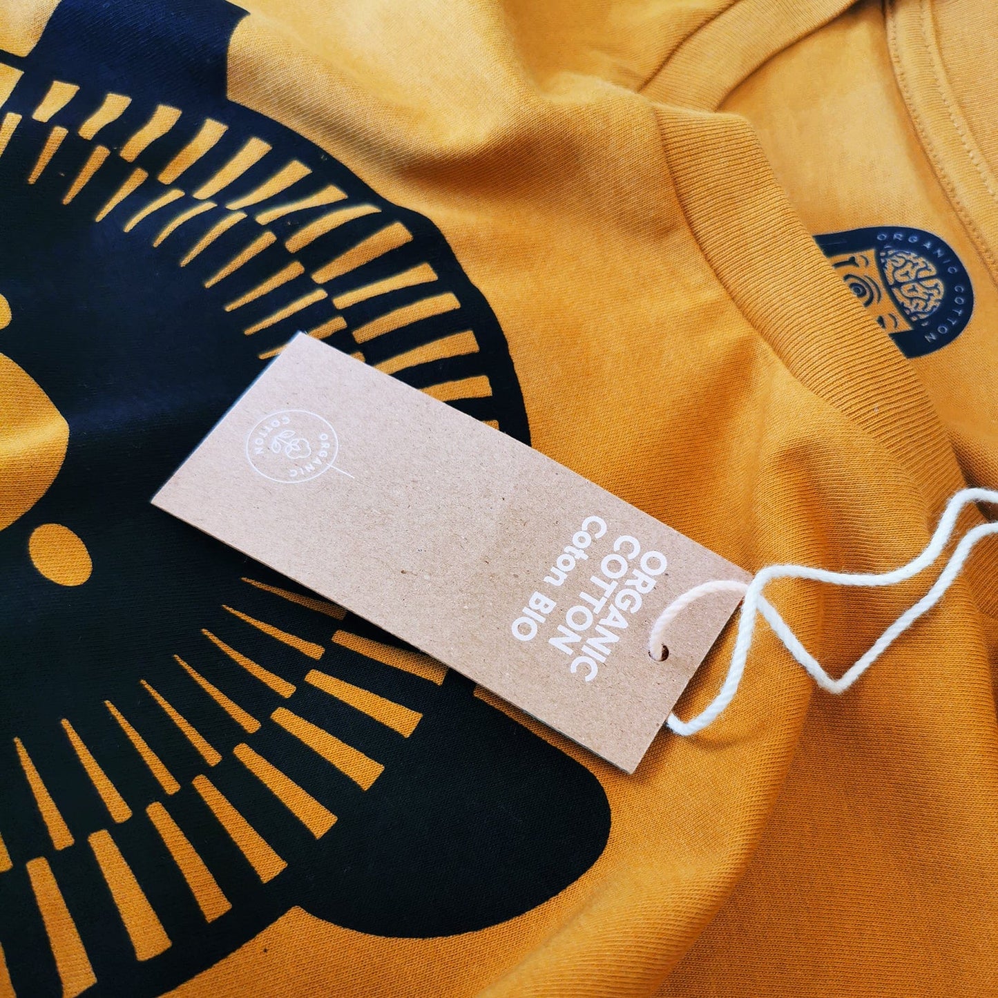 Close-up view of the organic cotton tag and the soft cotton thread of the Muso Bear Music T-Shirt