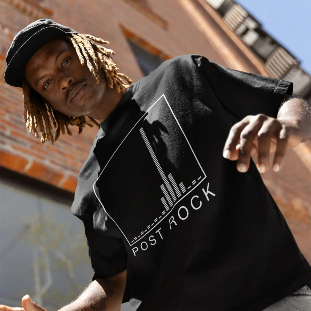 black-post-rock-t-shirt-worn-by-model-with-equaliser-graphic-outside-brick-building

