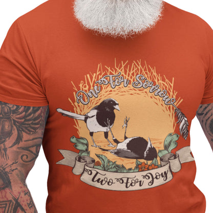 Paprika-red T-shirt featuring a dark reimagining of the “One for Sorrow, Two for Joy” nursery rhyme with illustrated magpies and a vintage folk-art aesthetic.